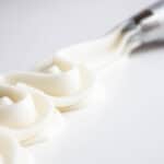 A line of cream cheese buttercream piped with a piping tip.